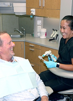Patient laughing with Norton Shores dental team member