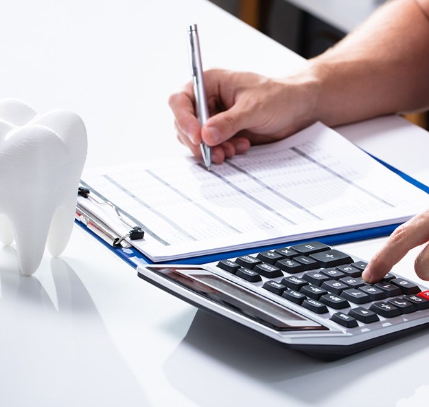 Patient in Norton Shores discussing root canal treatment costs with dental team
