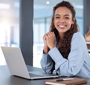 Woman smiling while working in office