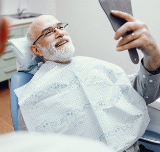 Man smiling with dental implants in Norton Shores