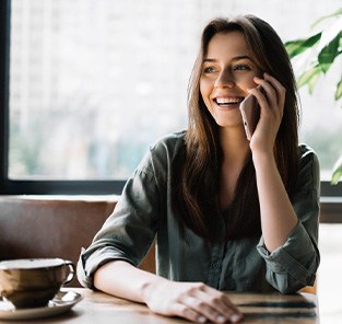 Woman smiling while talking on phone