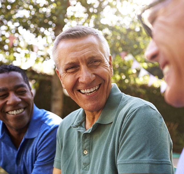 group of men smiling outdoors