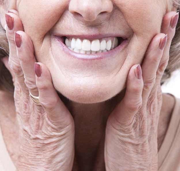 Closeup of senior woman smiling with dentures in Norton Shores