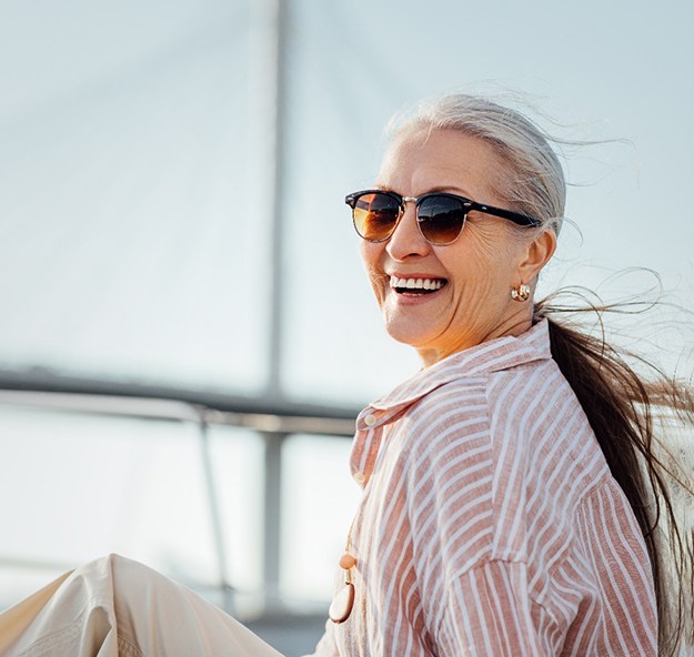 Senior woman sitting on a boat and smiling
