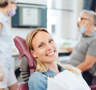 Woman smiling at a dentist in Norton Shores