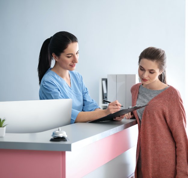 Dental team member and patient reviewing dental insurance coverage details