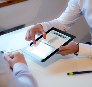 Dentist showing patient dental insurance information on tablet