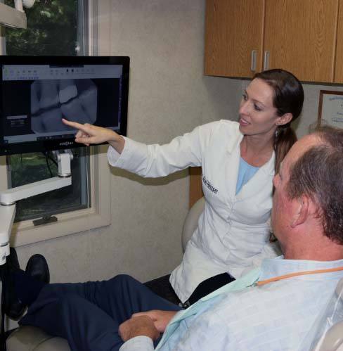 dental team member speaking with patient
