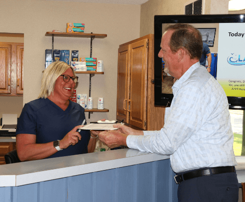 dentist working on patient's smile with dental assistant