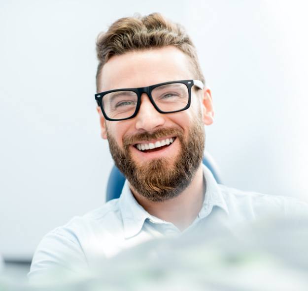 Man smiling during dental checkup and teeth cleaning visit