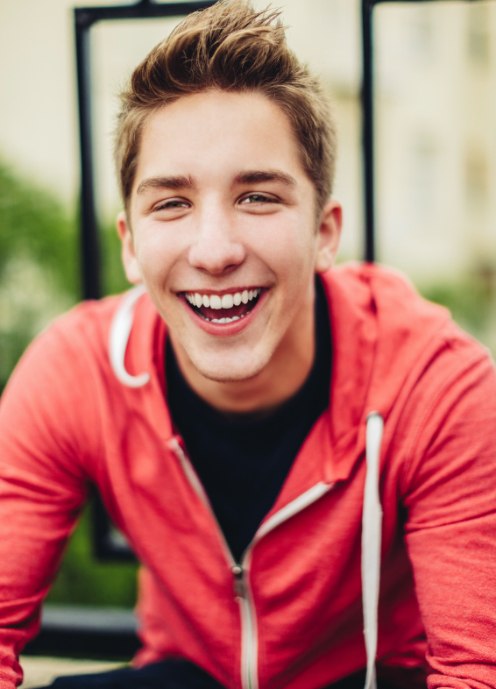 Young man smiling after restorative dentistry