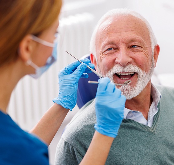 Man smiles at dentist