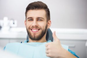 Man gives thumbs up for dental insurance coverage in North Shores