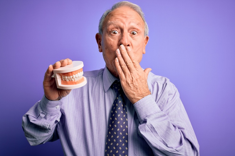 Elderly man afraid of talking with dentures